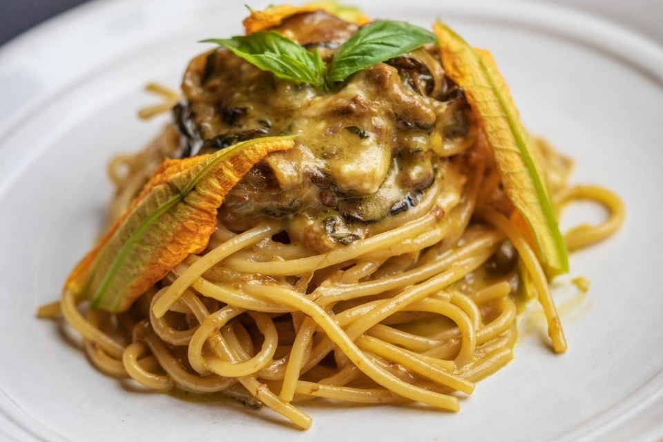 Close up shot of spaghetti with cream sauce and vegetables