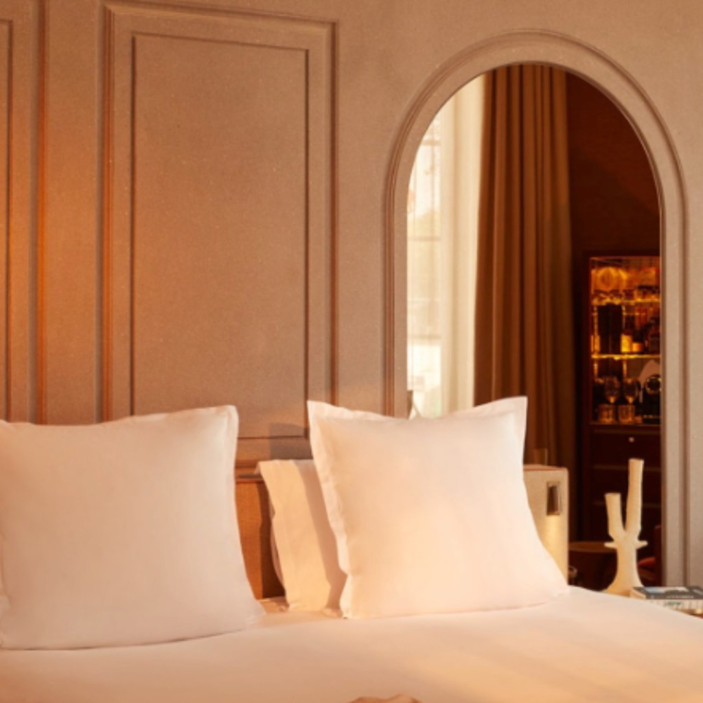 White bed with cream walls behind it