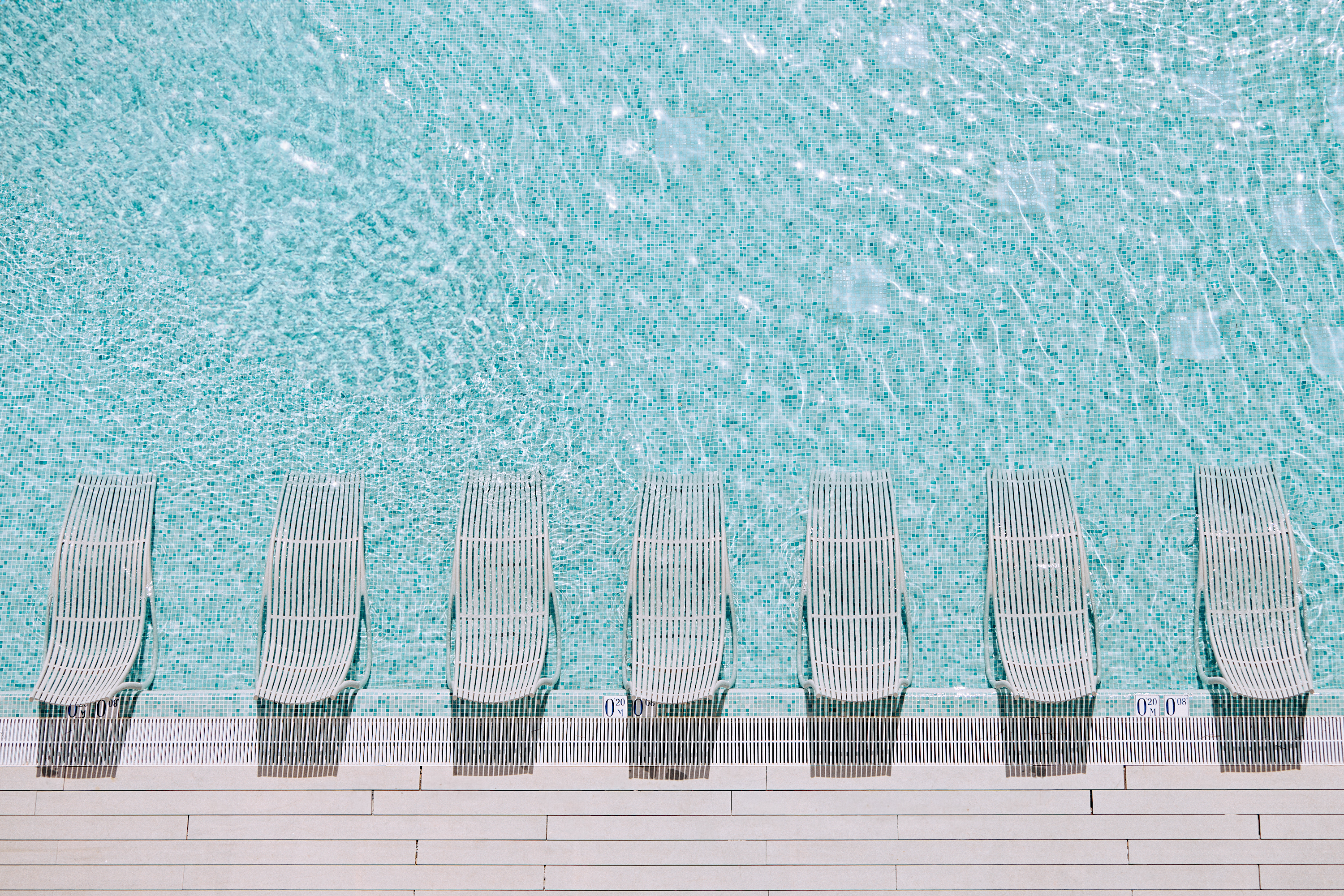 Hyde Ibiza Wet Deck Pool with white sun loungers.