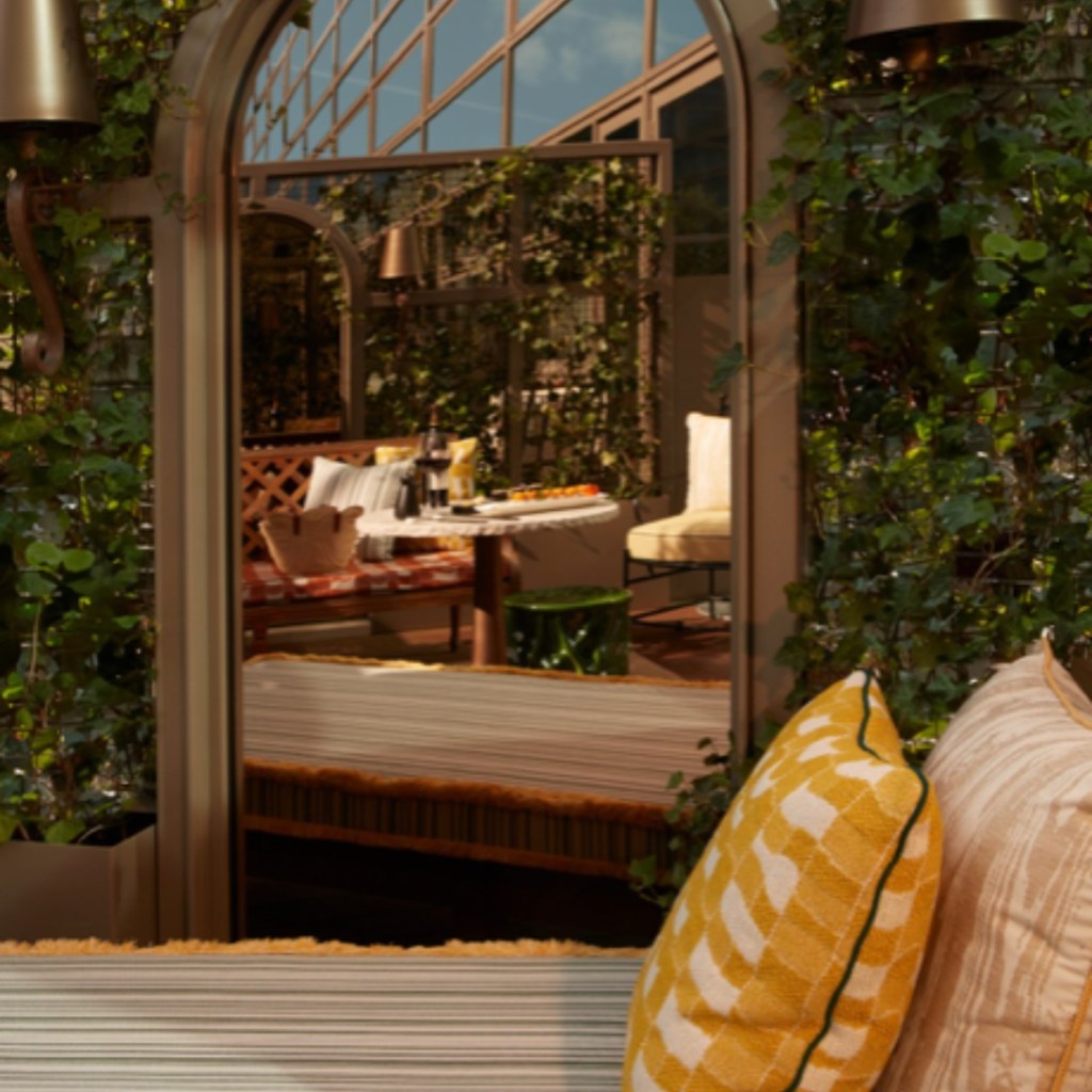 Outdoor chaise lounge with greenery wall
