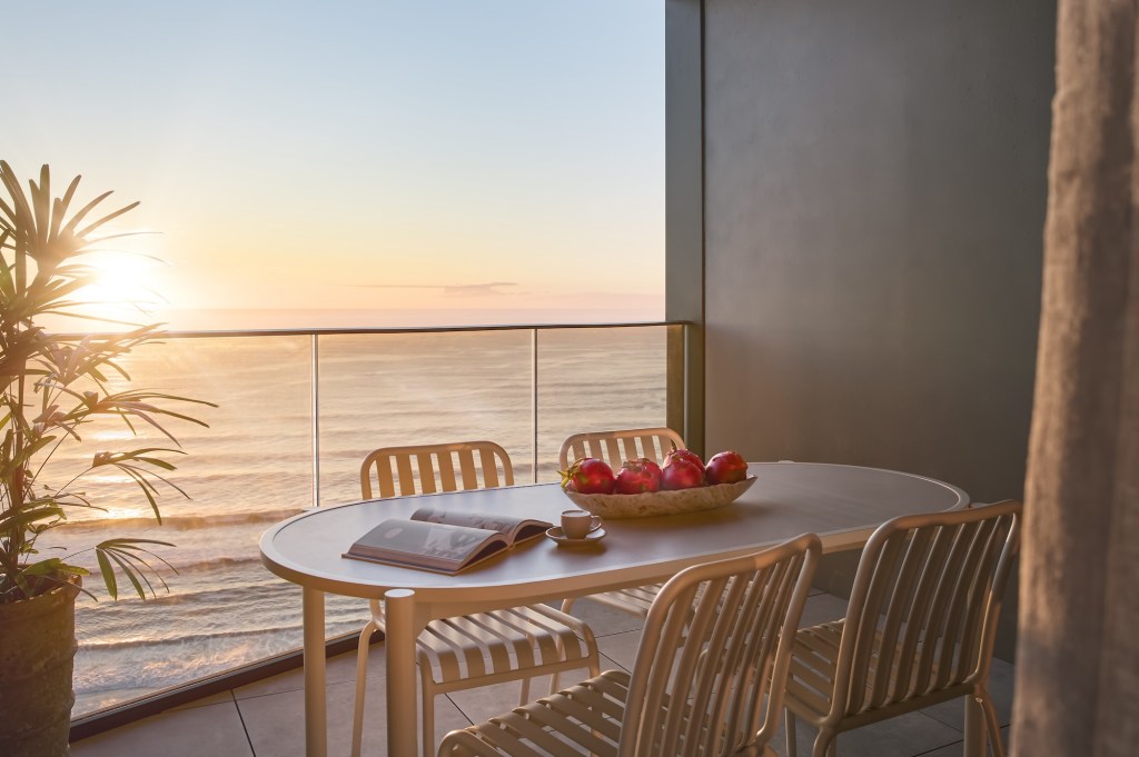 Balcony with dining table looking out to the ocean