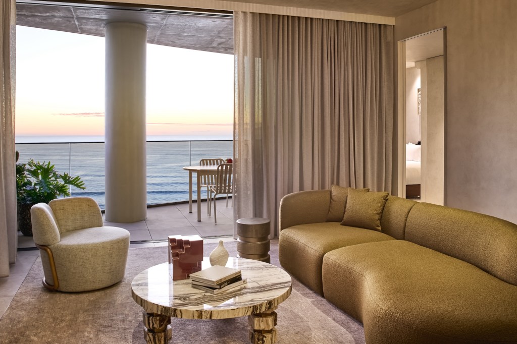 Large modern sofa and cream lounge chair in a spaciousl living room