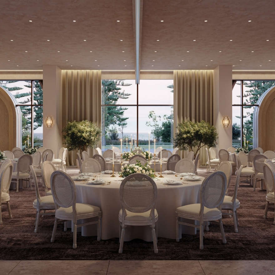 Ballroom set up with round tables and white tableclothes and white chairs