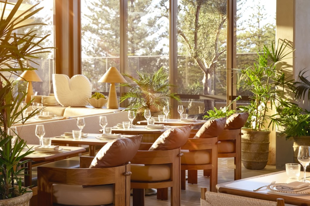 Bright, naturally lit dining room with row of leather pillowed chairs