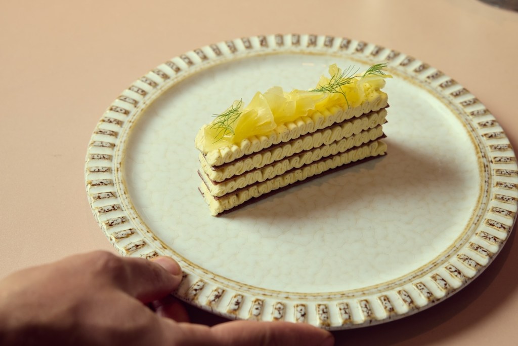 Slice of lemon cake on a white round plate