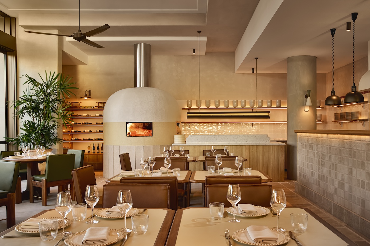 Large restaurant dining room with woodfire oven in back