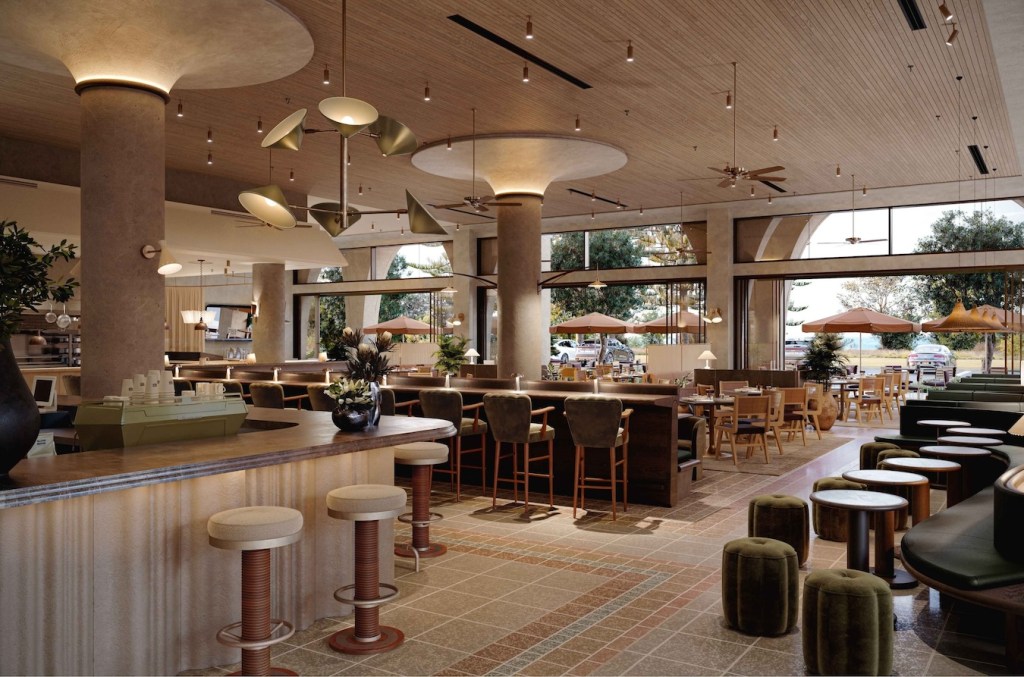 Large warmly lit dining room with coffee bar, bar with green velvet bar stools, and tables with booths and green velvet chairs