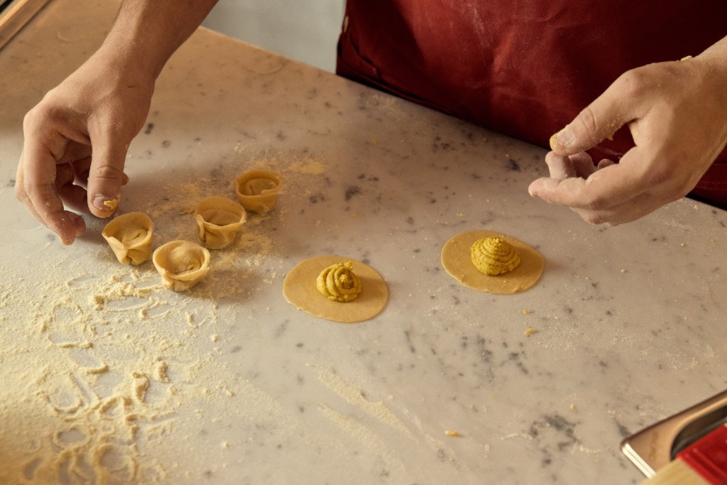 Ravioli being handmade on a counter