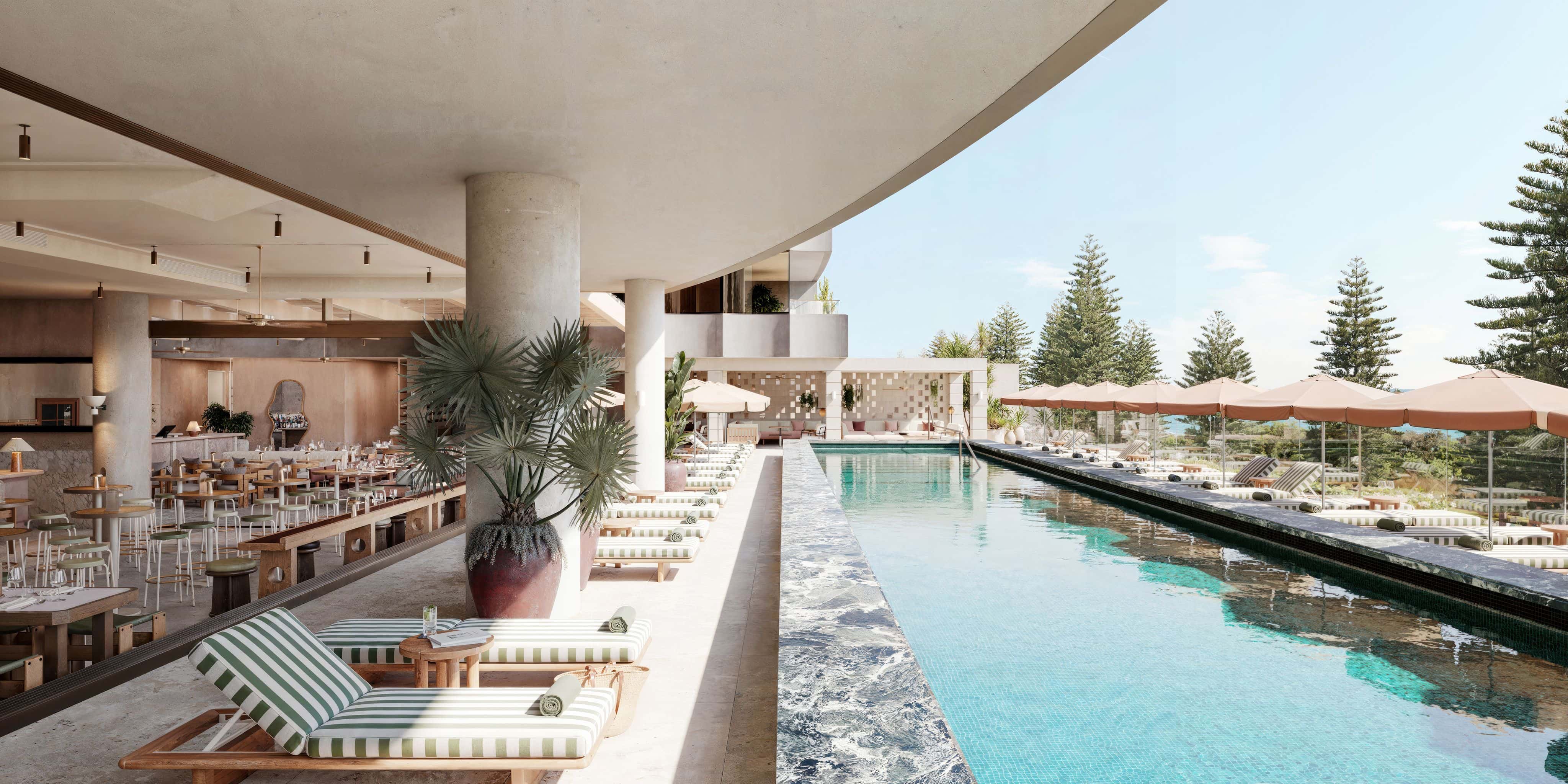 Pool club with large rectangular pool and striped chaise lounges on one side, and cabanas on the other