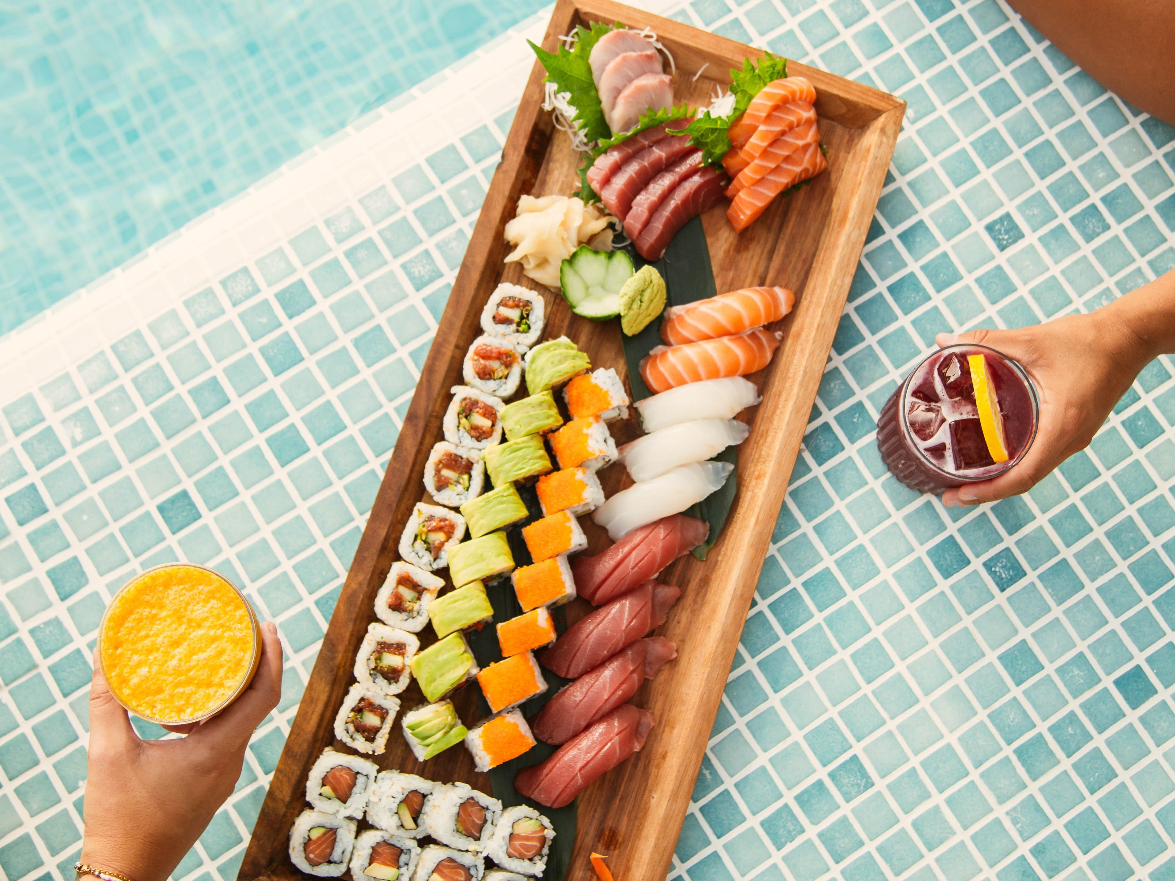 Set of variety of sushi by the pool accompanied with refreshing cocktails