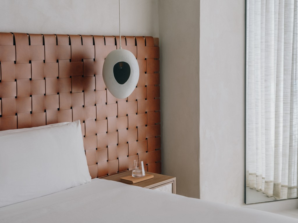 Good Mondrian Ibiza One Bedroom Suite Sea View, Side of white bed with rust colored headboard and curtains covering a balcony window