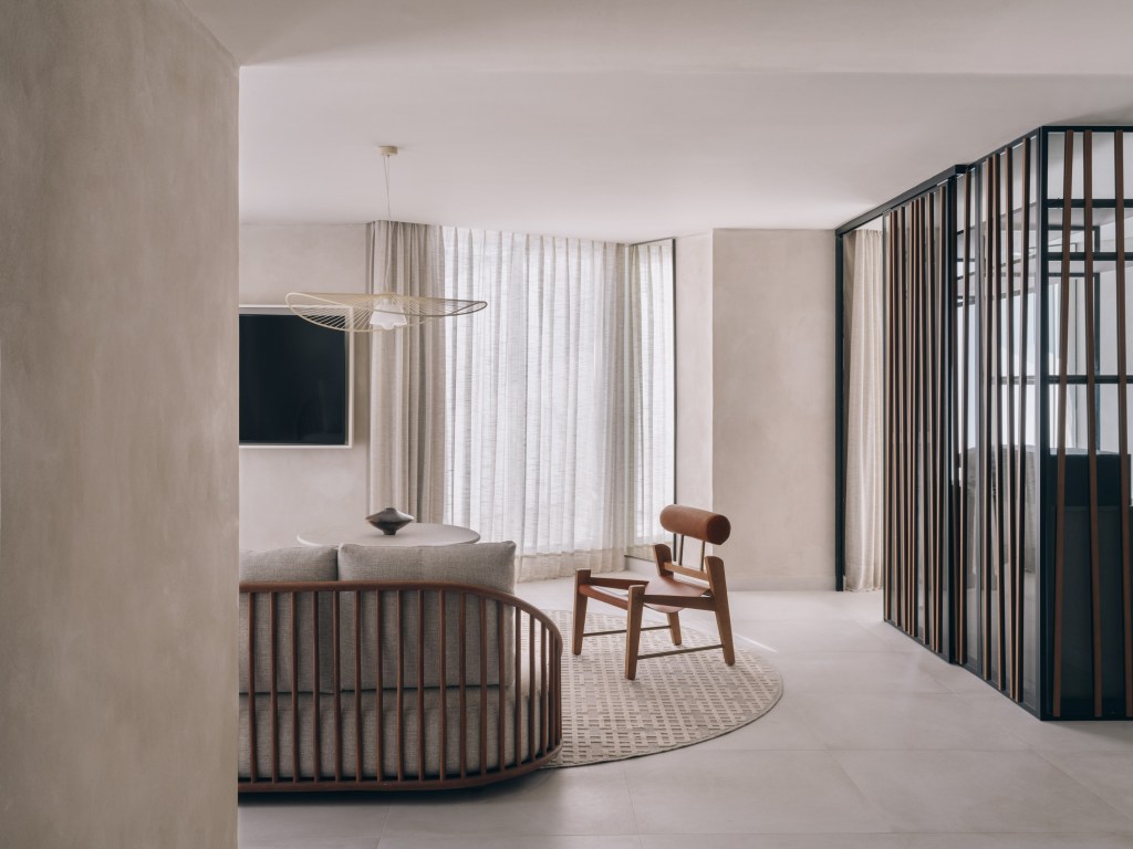 Mondrian Ibiza Presidential suite A modern living room with a wooden chair and a television.