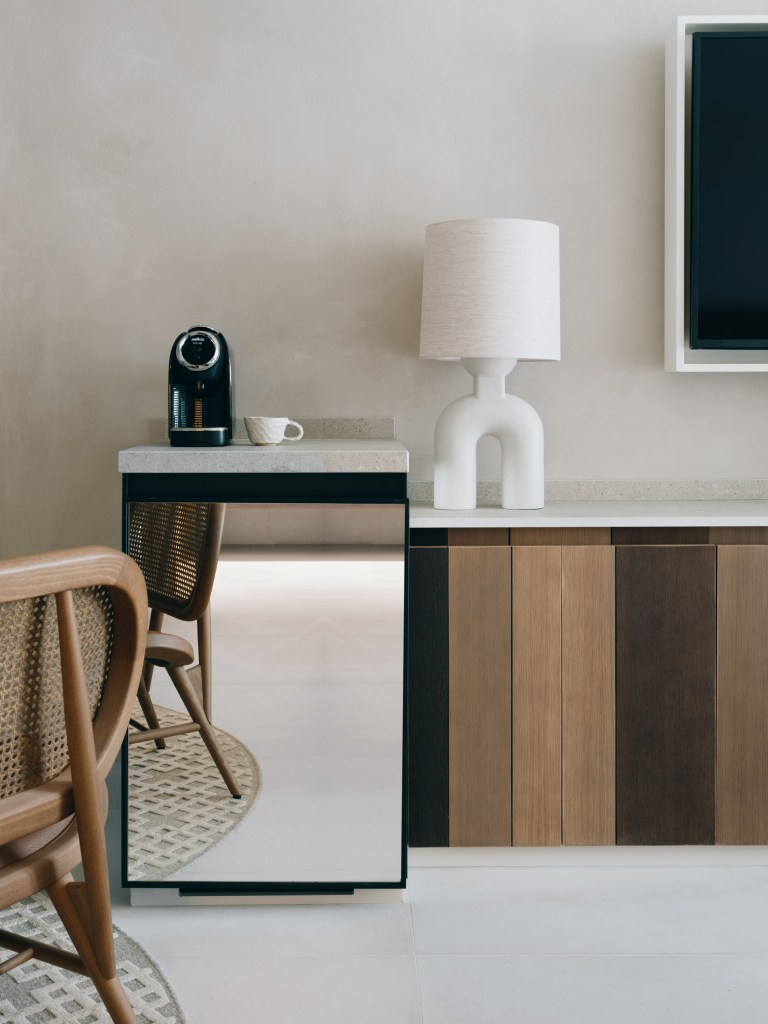 Mondrian Ibiza - Hotel room silver mini fridge with console with a white table lamp on top