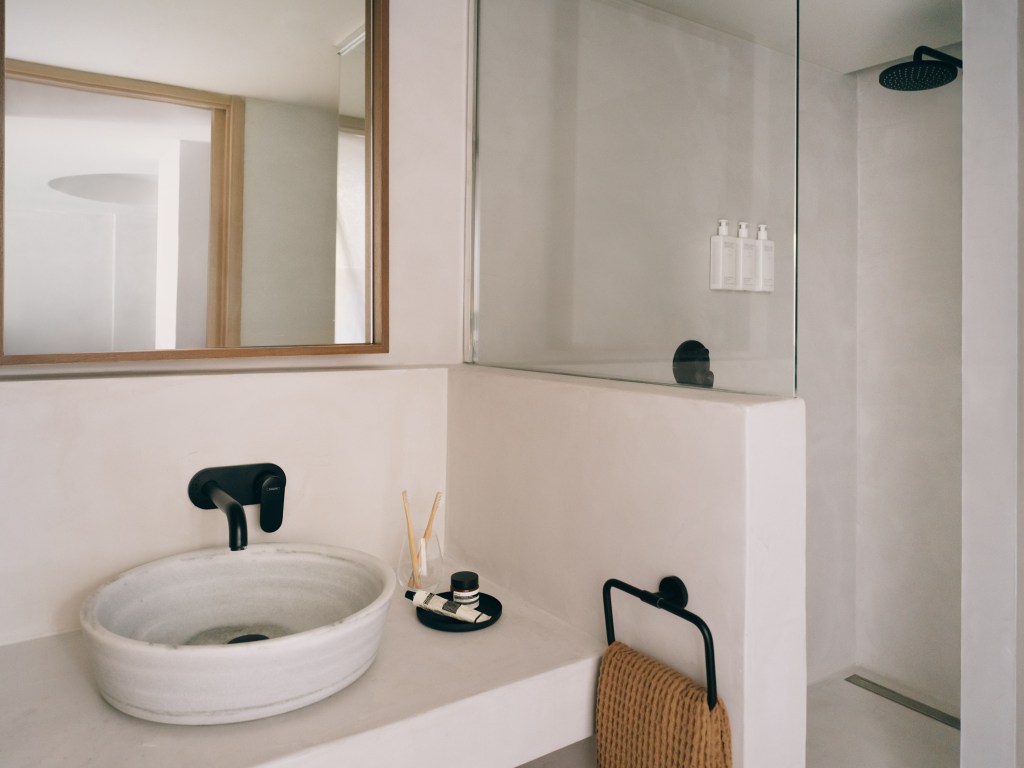 Mondrian Ibiza Deluxe King Bathroom with white countertops, white sink, and large square framed mirror