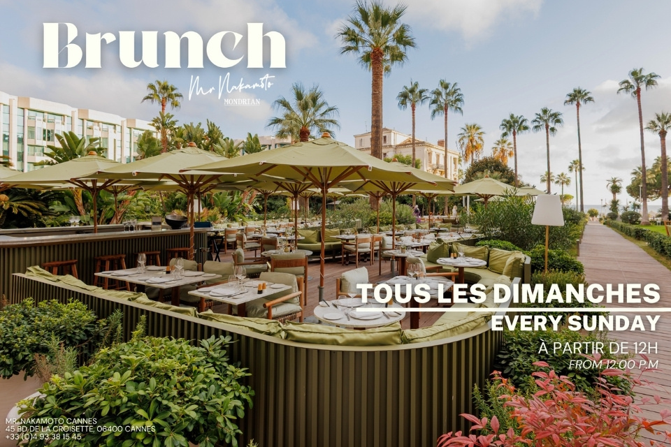 Outdoor restaurant with green umbrellas over tables and palm trees throughout