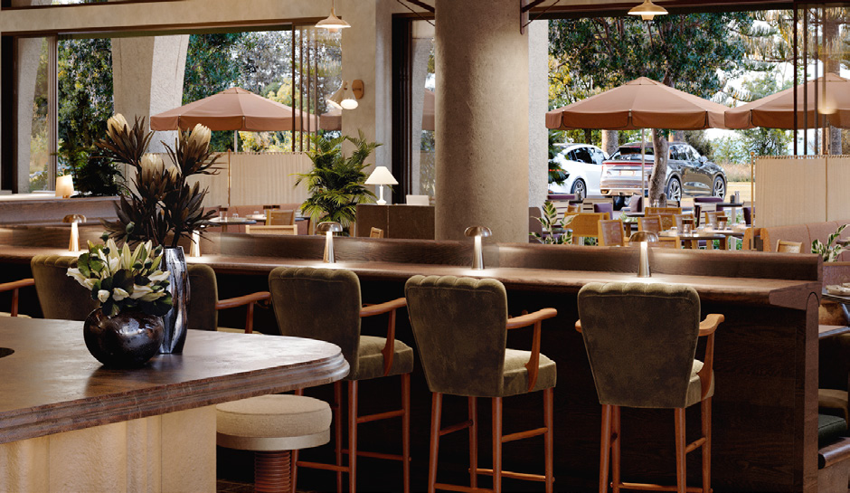 Green velvet barstools lined up against a light wood bar