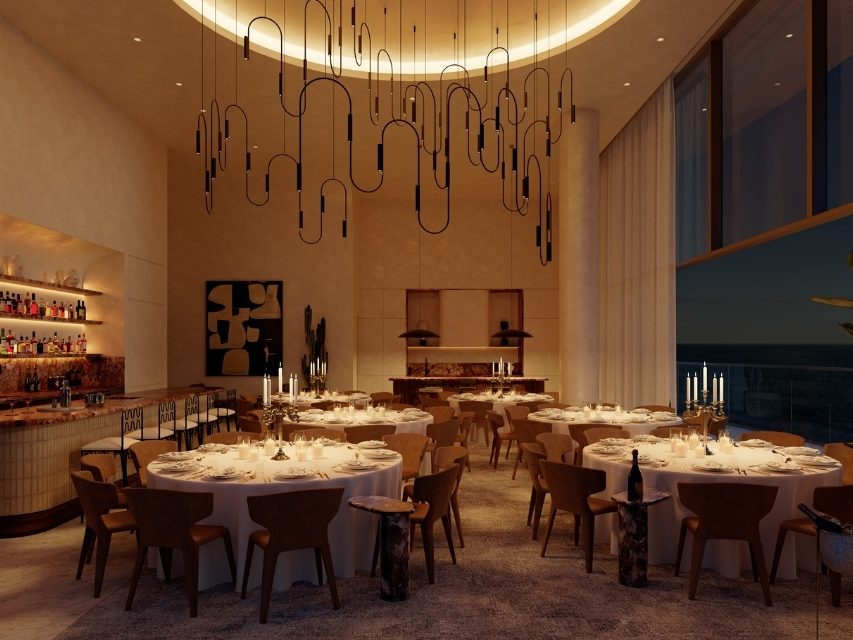 Dimly lit room with large circular tables set up for a dinner