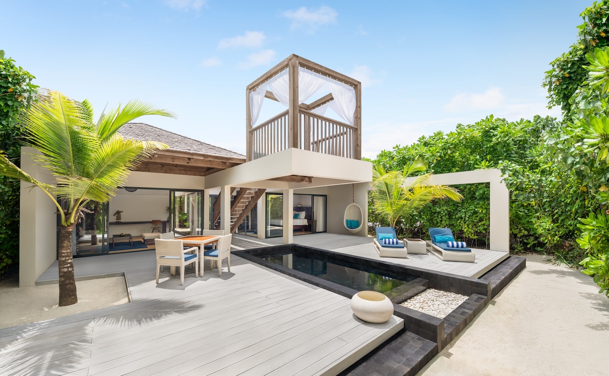 Outdoor villa in a tropical location with palm trees surrounding