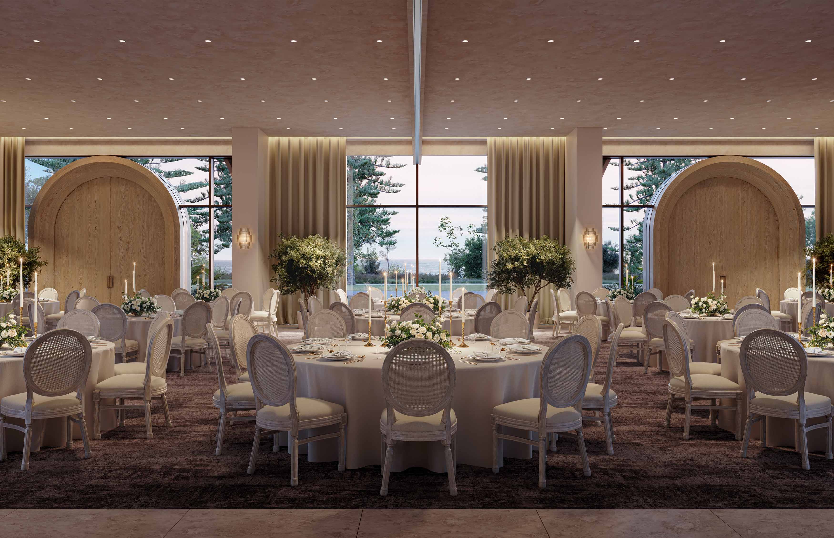 Large ballroom set up for a wedding with white tables and chairs