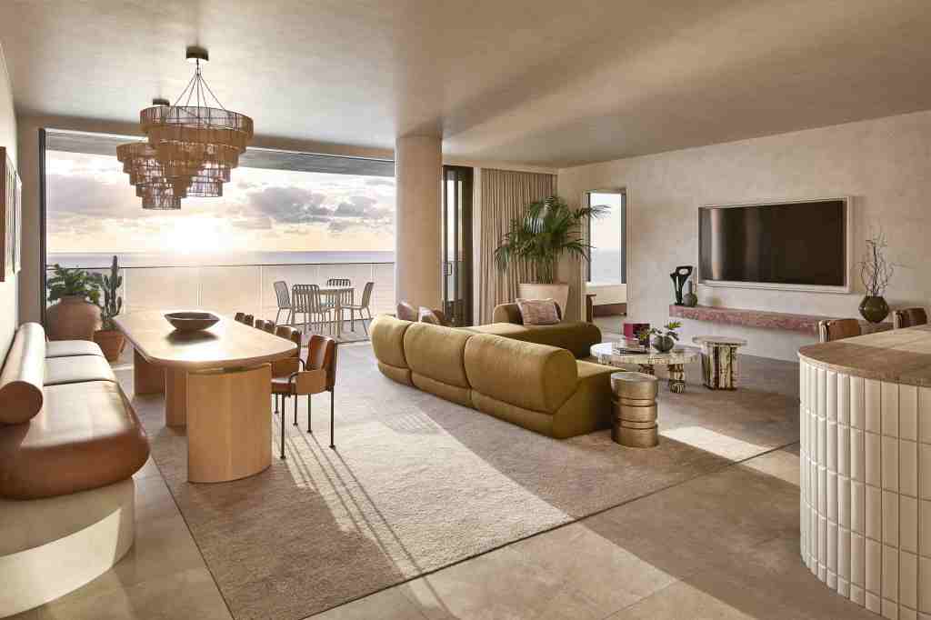 Large, light-filled suite with floor to ceiling windows, chandelier, modern sofa, and more