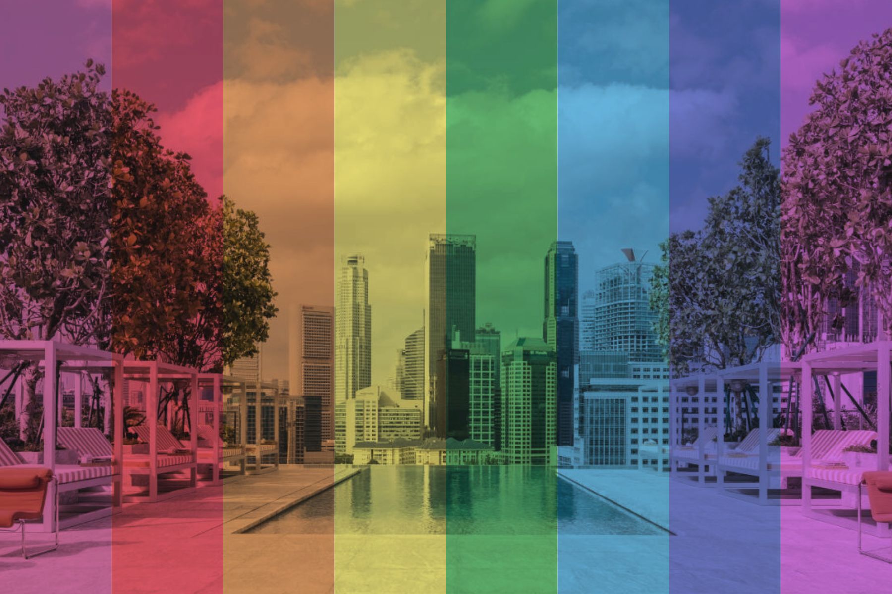 rainbow filter of rooftop pool with city views in the background