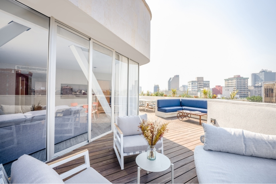 Large outdoor terrace with various furniture