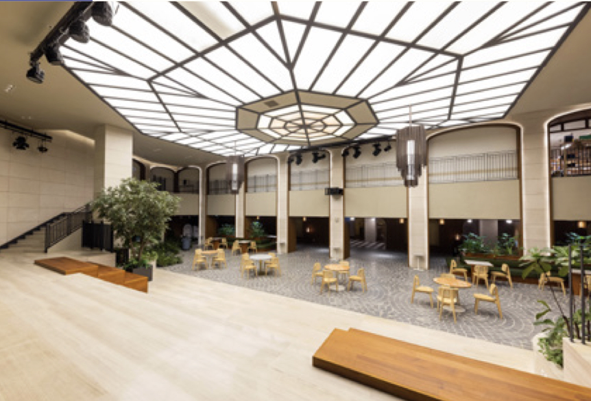 Large event space with expansive window on the ceiling and beige, warm colors 