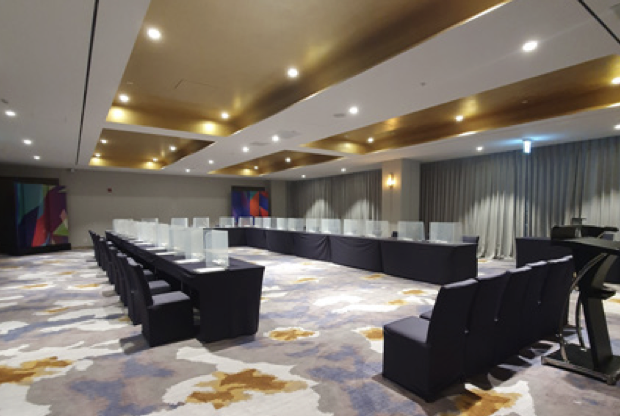 Patterned carpet floor in a large ballroom space with long rectangular tables