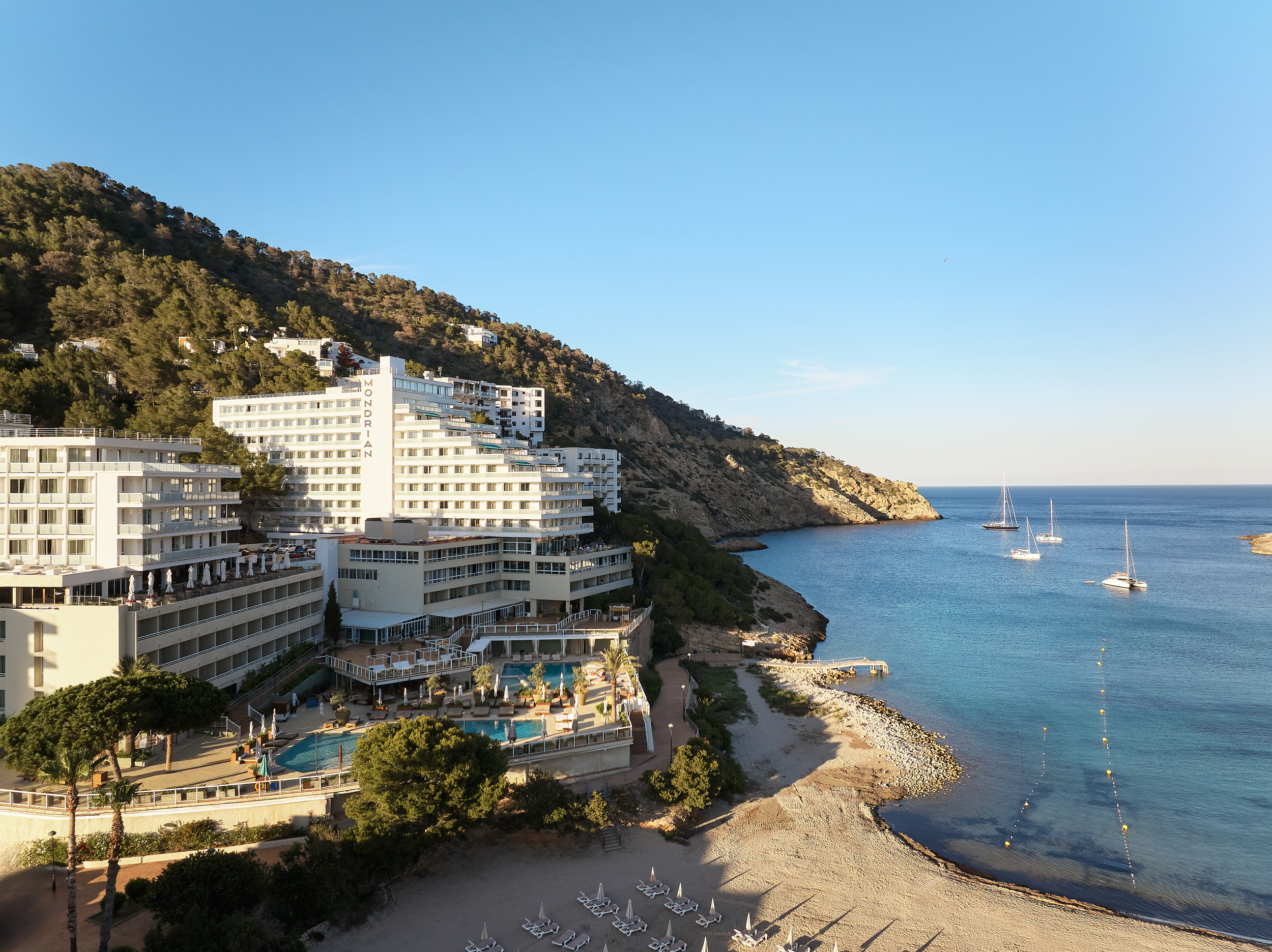 Cala Llonga, Beach Mondrian building, sunset, sea views