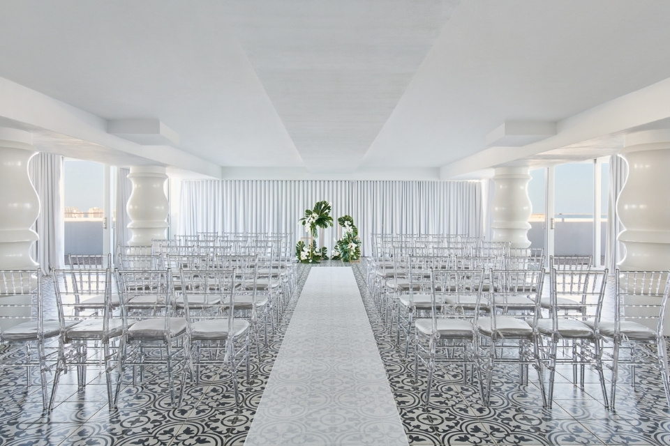 Large ballroom space set up for a wedding ceremony