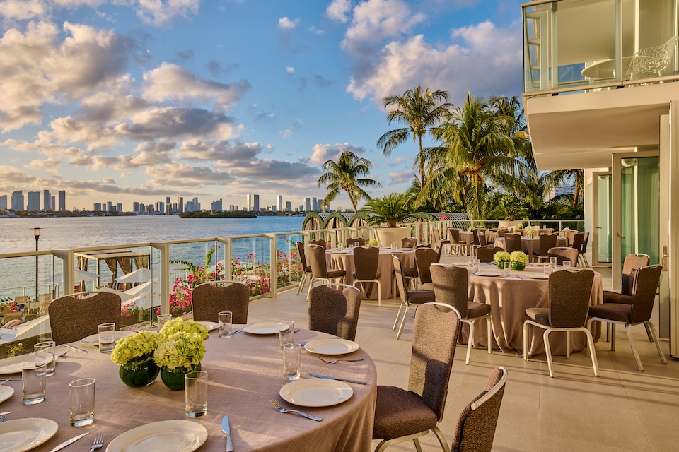 Outdoor dining set up with palm trees