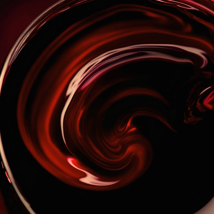 Close up image of red wine swirling