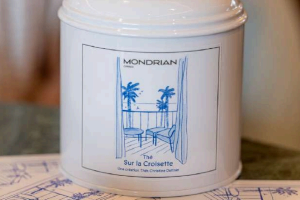 White tea jar with blue illustration of palm trees