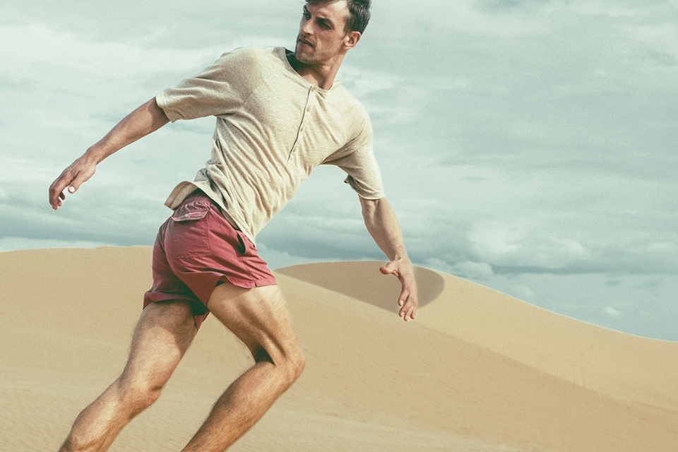 Man in red swim trunks running on beach