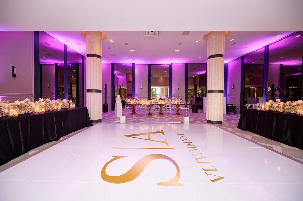 Large ballroom with purple lights and white dance floor