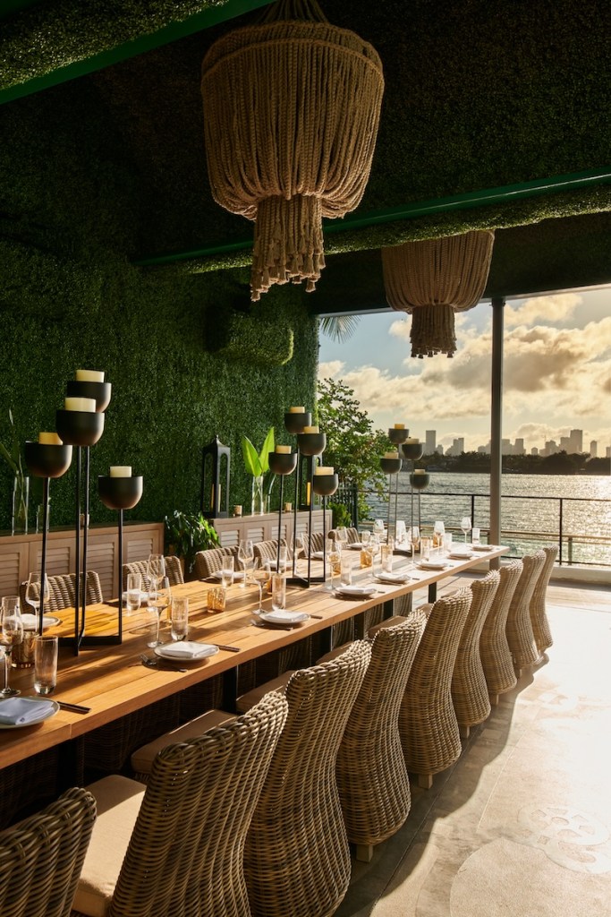 Greenery wall with large rectangular table and chairs