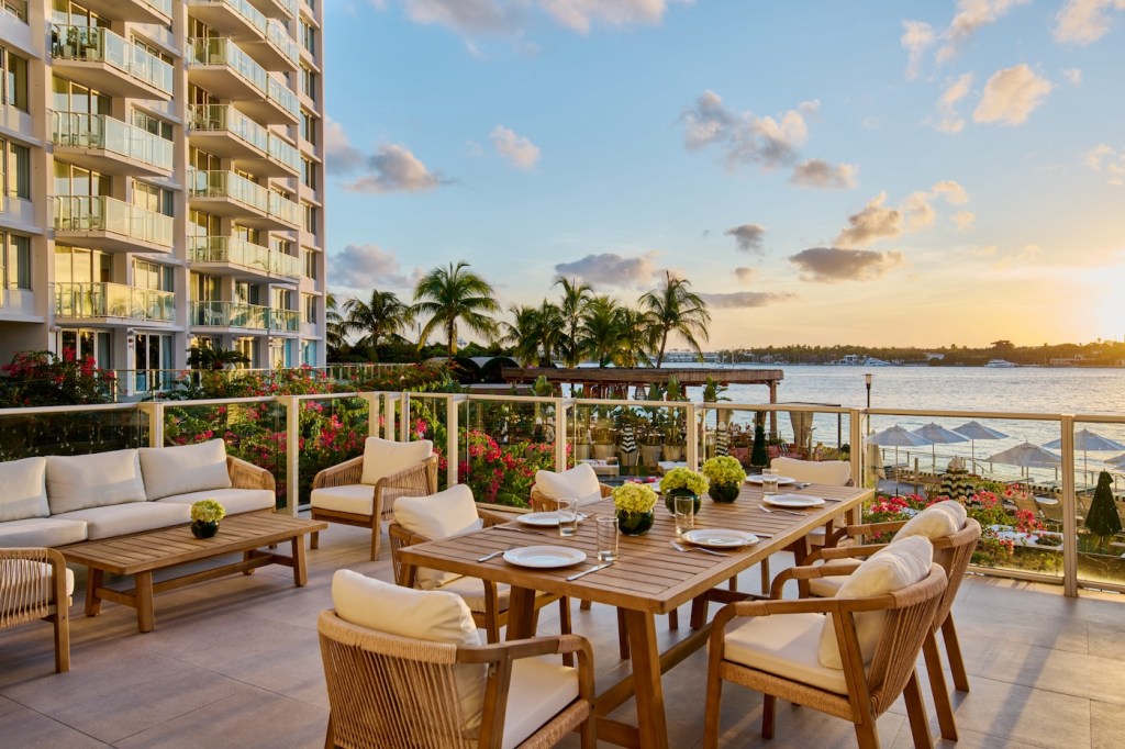 Outdoor patio space with large wooden table and chairs