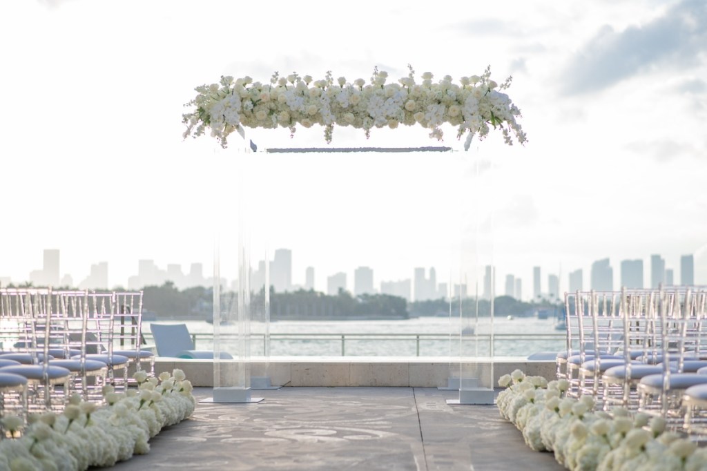 Outdoor patio wedding reception set up with white florals