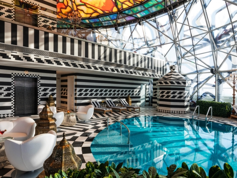 Indoor pool with black and white striped floors and walls