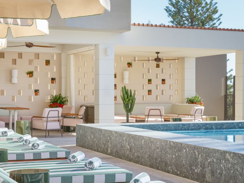 pool with striped chaise lounges