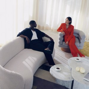 Man and woman sit in lounge area