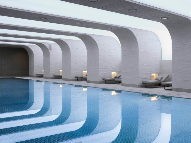 indoor pool with white columns overhead