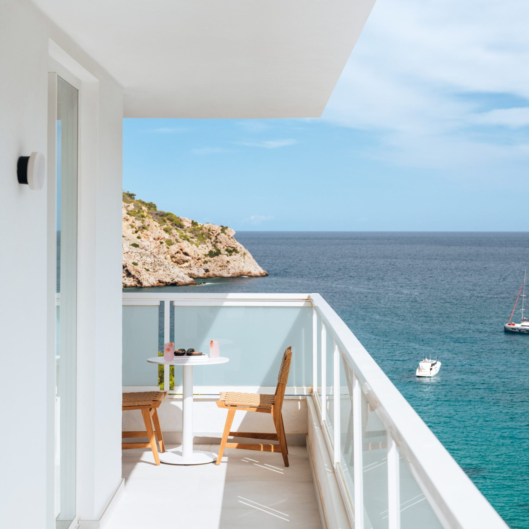 Mondrian Ibiza Panoramic - A serene ocean view from a balcony with a table and chairs.