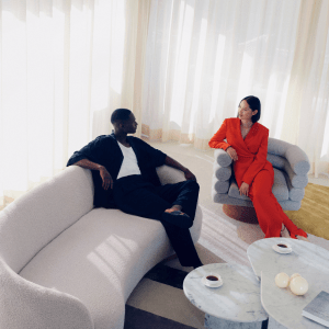 Man and woman sit in lounge area