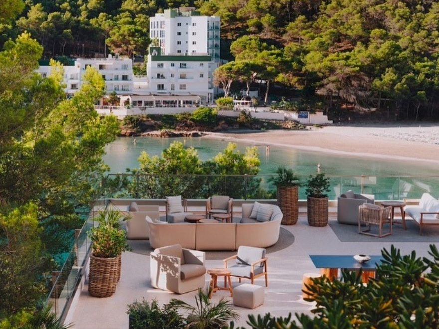 Balcony overlooking the sea with a white building in the distance