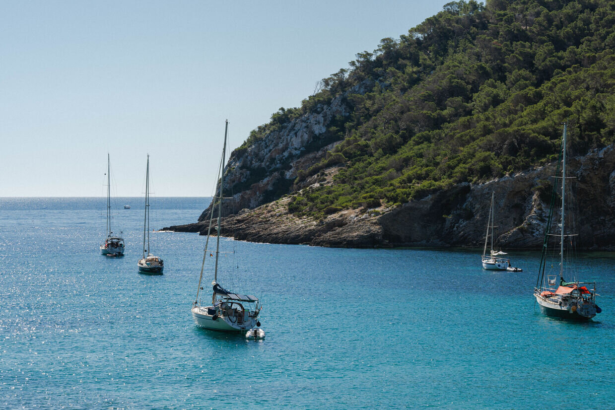 Mondrian Ibiza balcony views to crystal clear Turquoise water of the Mediterranean sea at Cala Llonga Beach