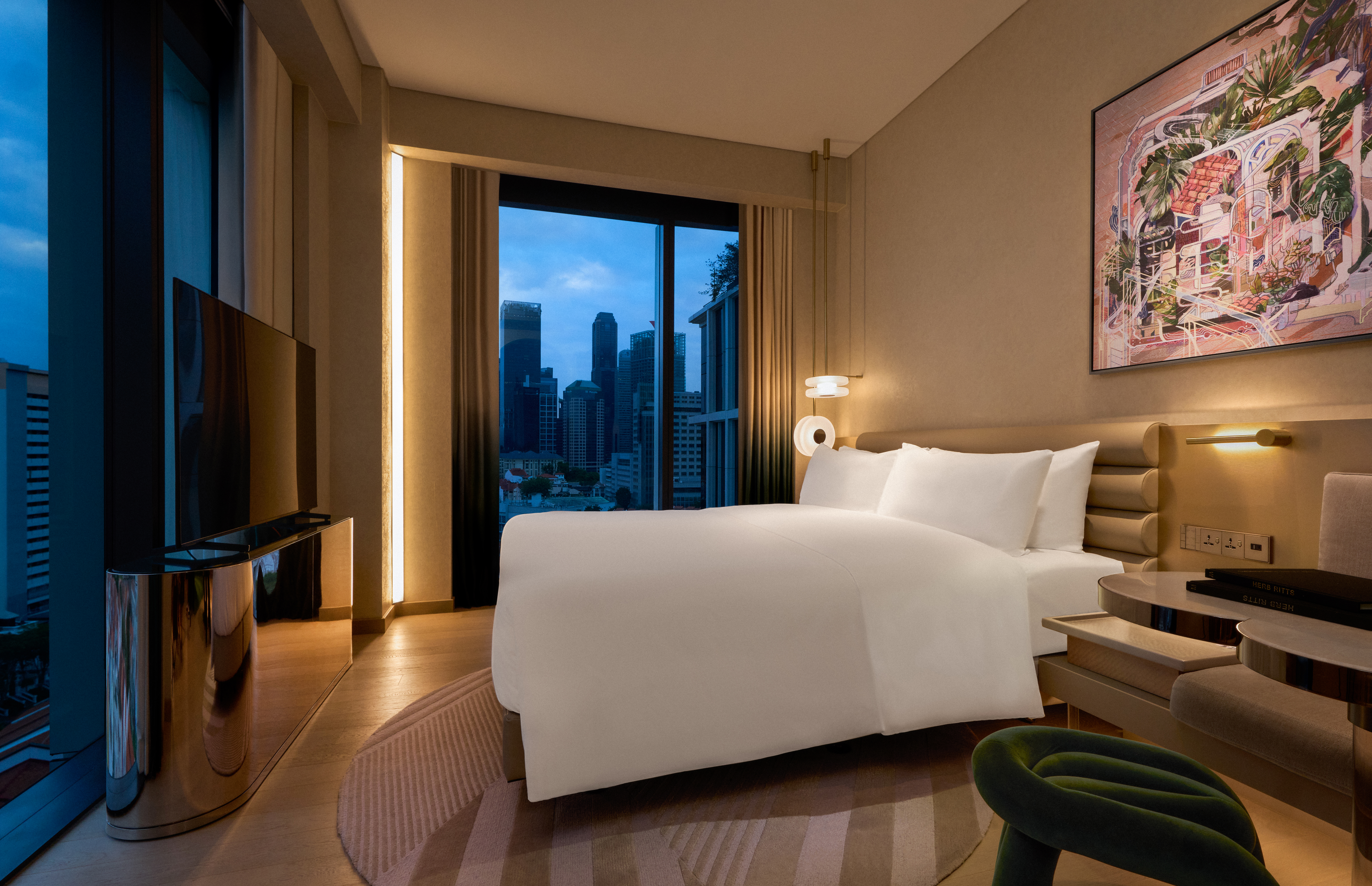 Signature corner room at dawn with floor to ceiling windows on two sides of the room.